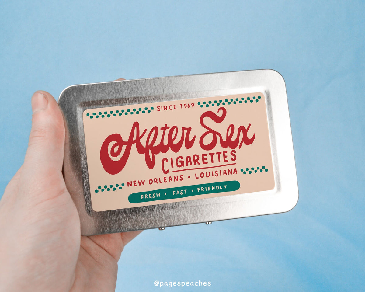 a person holding up a tin with a label on it