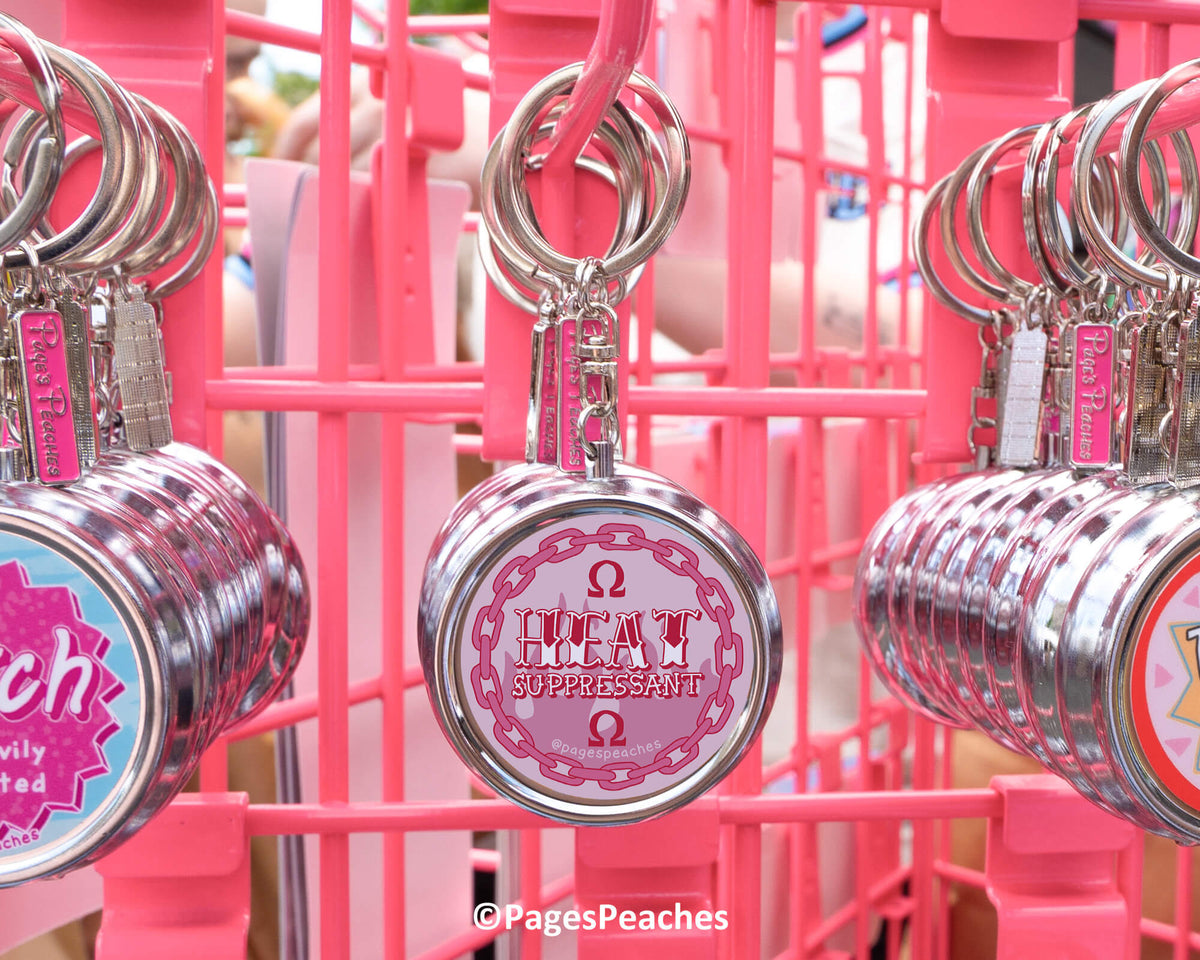 a pink metal rack displaying a variety of keychains, each with a unique design and color.
