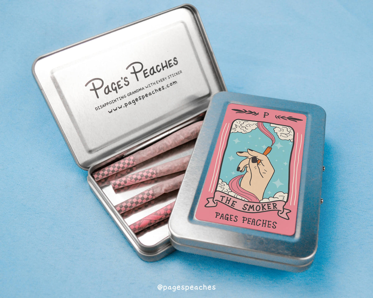 a metal tin with pink matches inside of it