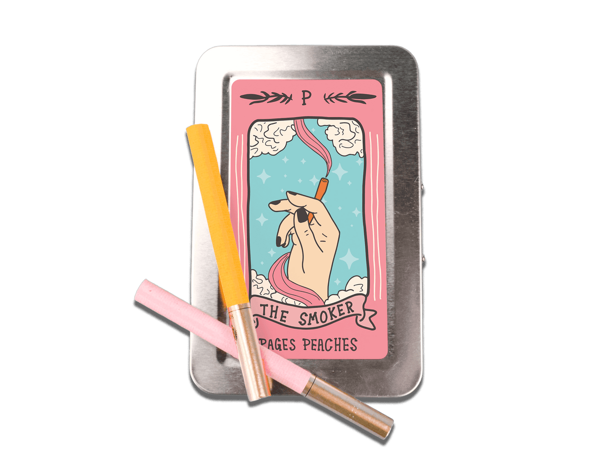 a tin with a cigarette in it next to a cigarette holder