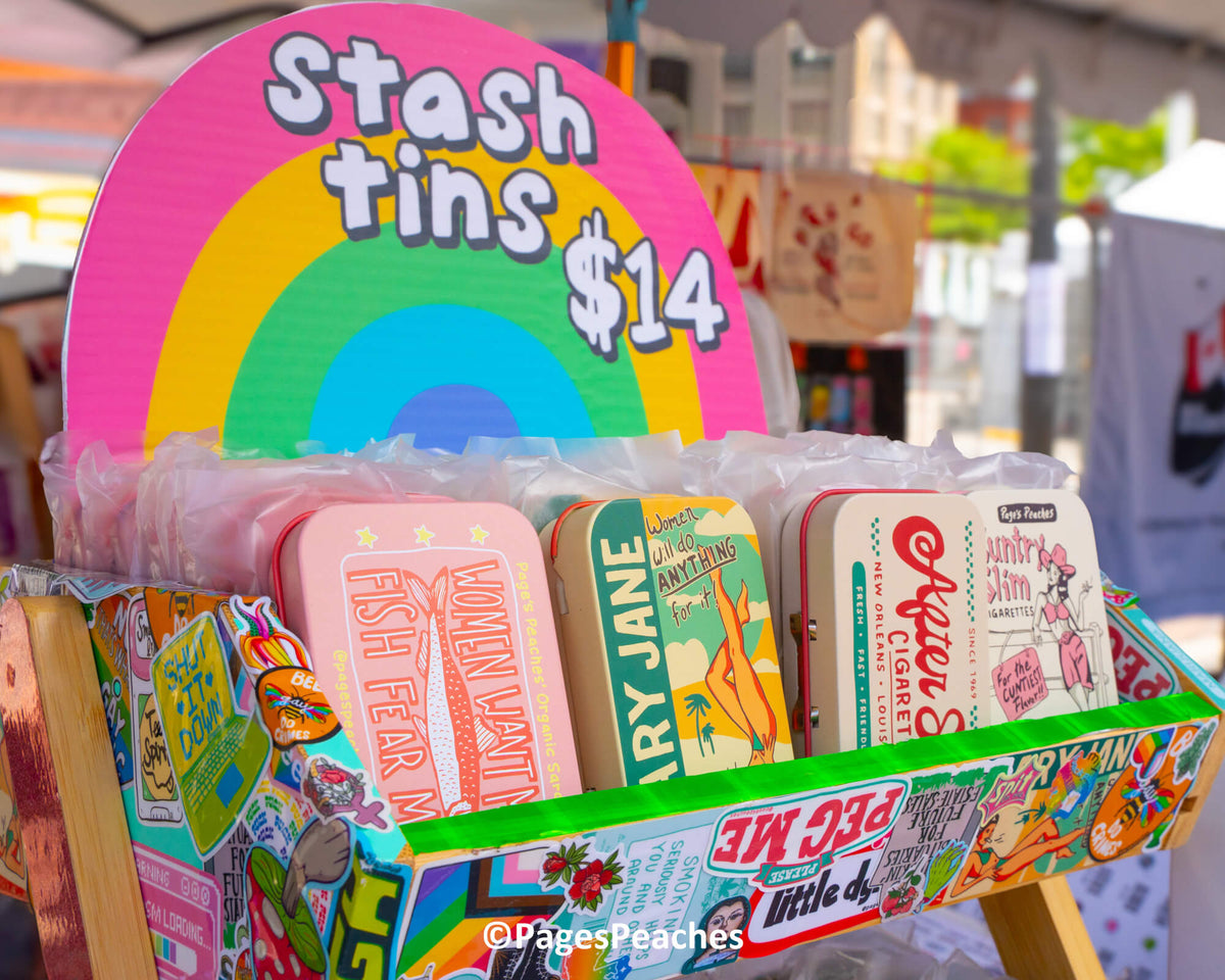 A colorful display of various tin cans, each with a different design and price tag, arranged on a stand.