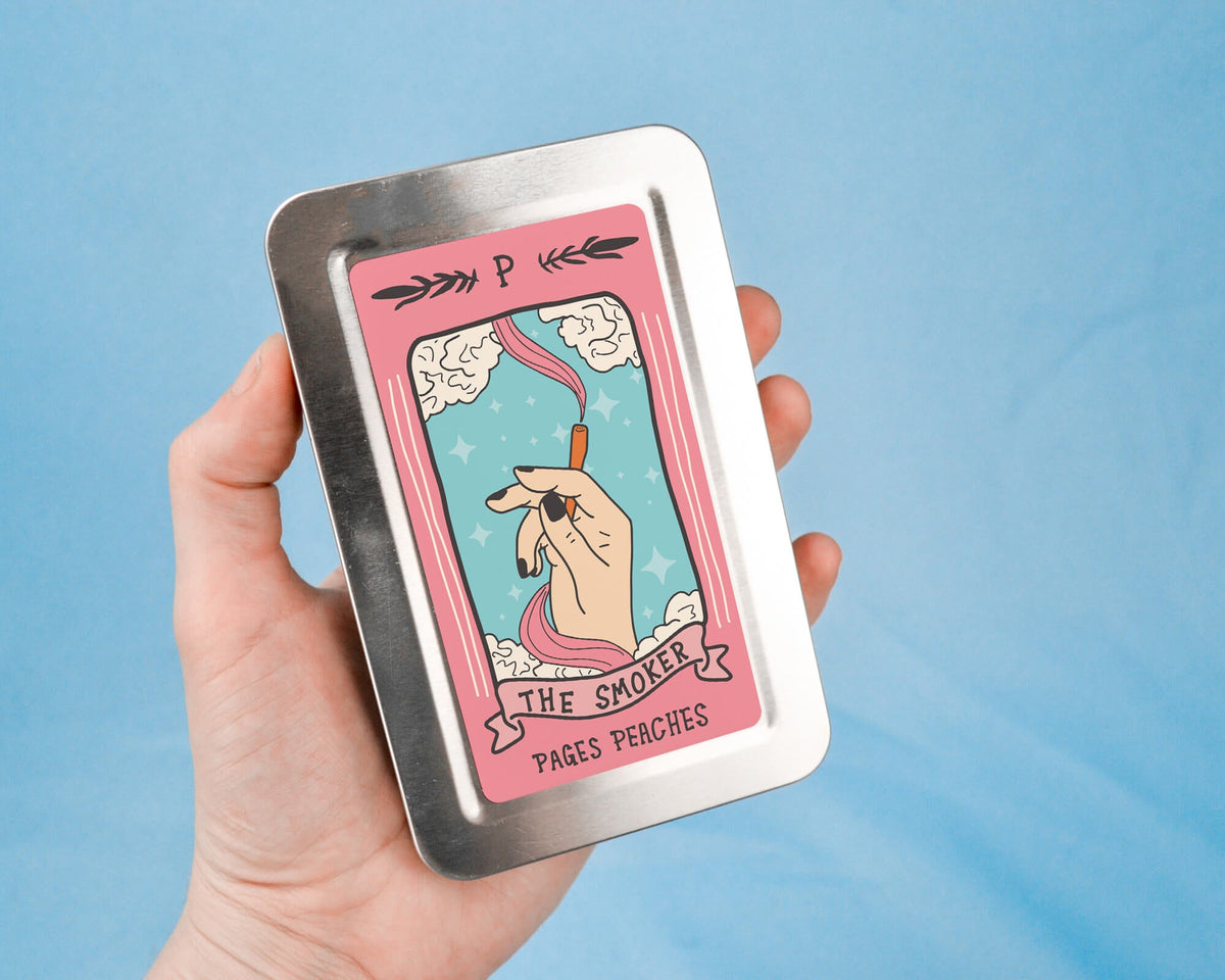 a hand holding a tin with a picture of a unicorn on it