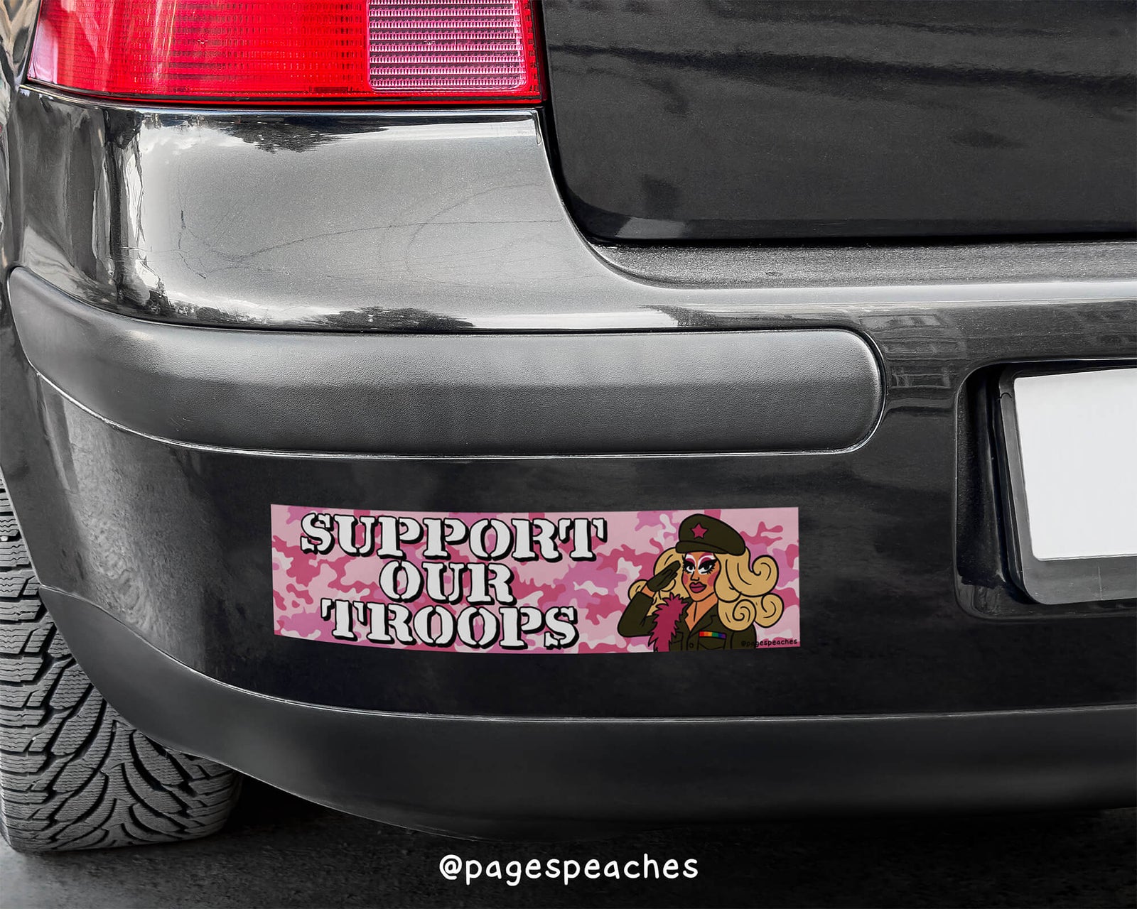 Bumper sticker reading “Support Our Troops” on a pink camo background