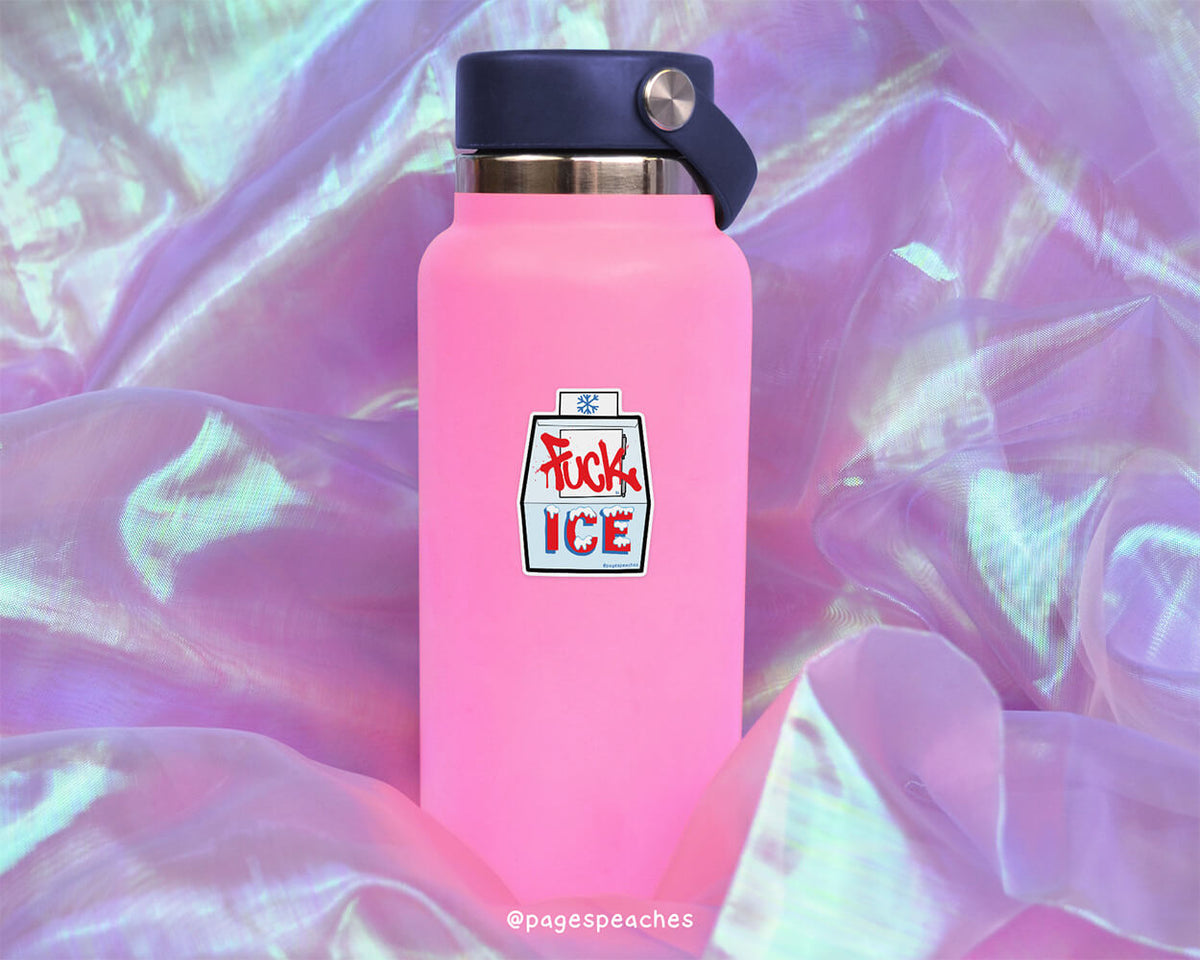 A pink water bottle with a black cap and a sticker that says "FUCK ICE" is placed on a purple fabric background.