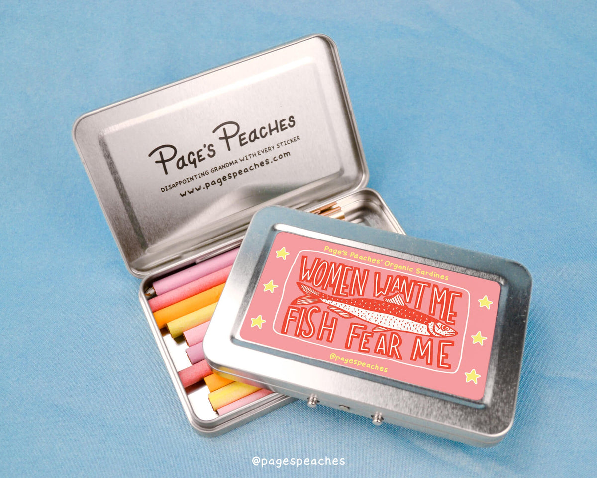 a tin of colored pencils sitting on top of a blue surface