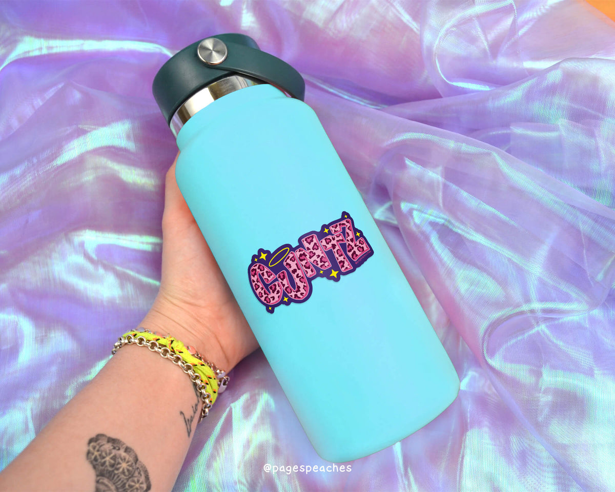 Light blue water bottle with pink and purple design held against a colorful, iridescent background.
