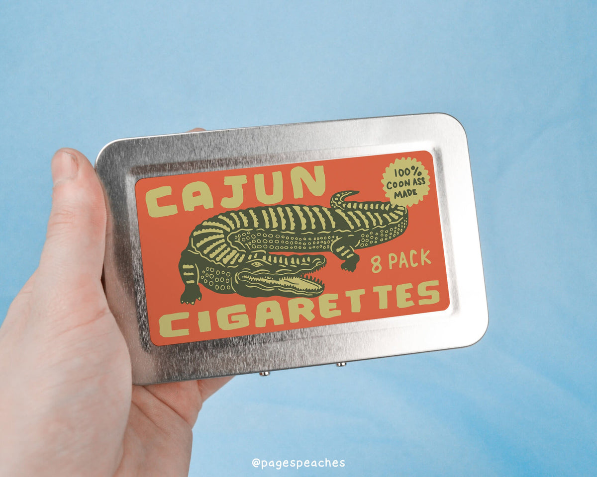 a person holding a tin with a picture of a lizard on it